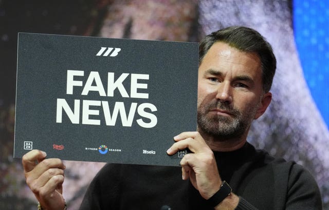 Eddie Hearn holding up a sign instead of speaking