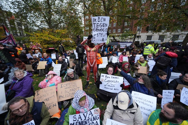 Campaigners at the Defend Our Juries protest in support of Palestine Action at The Peace Garden, Tavistock Square, central London