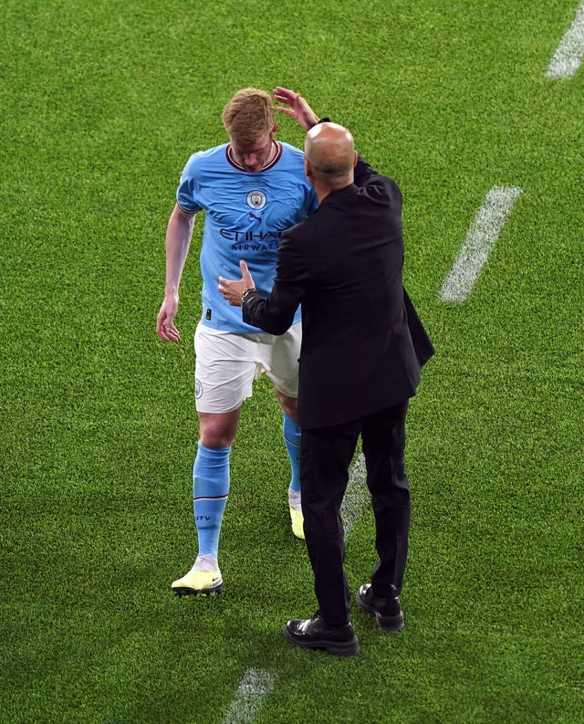 Kevin De Bruyne is consoled by manager Pep Guardiola as he walks off injured