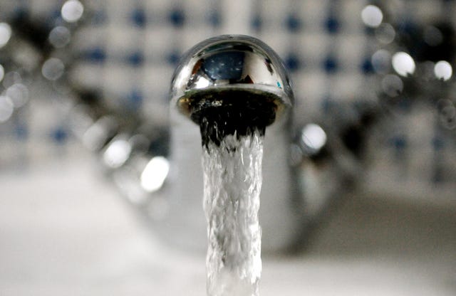 Water gushing out of a tap