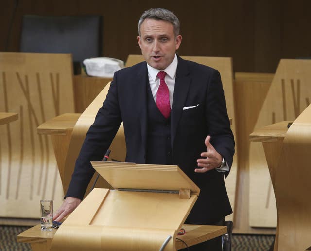 Alex Cole-Hamilton standing while speaking in the Scottish Parliament