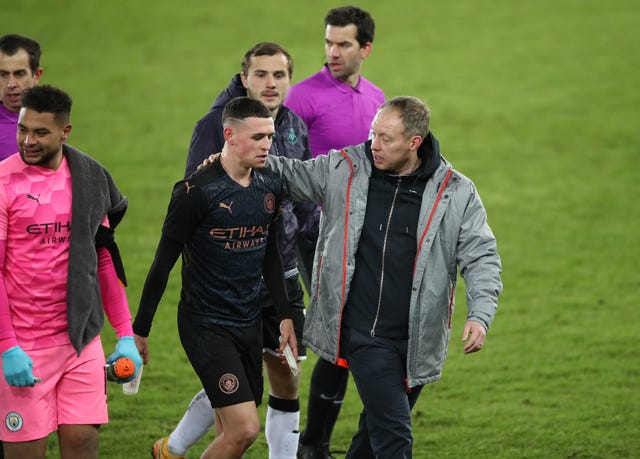 Manchester City’s Phil Foden, left, with Swansea manager Steve Cooper