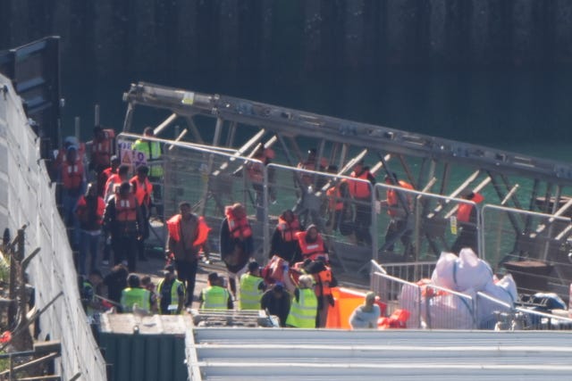 People thought to be migrants are brought in to the Border Force compound in Dover