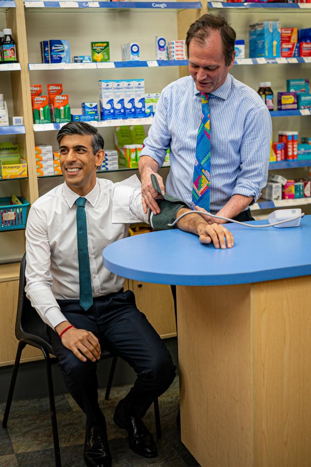 Prime Minister Rishi Sunak has his blood pressure checked by pharmacist Peter Baillie