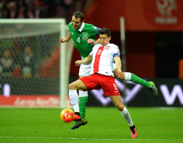 Republic of Ireland defender John O’Shea tackles Poland’s Robert Lewandowski
