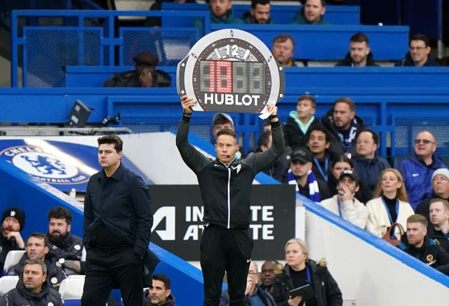 The fourth official holds up a board to show 10 minutes of added time in the Chelsea v Wolves Premier League match at Stamford Bridge in February 2024