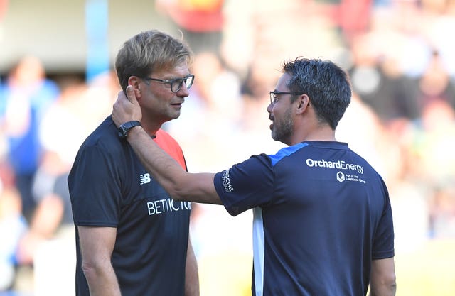 Liverpool manager Jurgen Klopp (left) and David Wagner greet each other