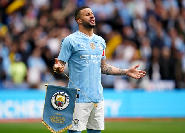 Manchester City’s Kyle Walker holding a pennant ahead of the FA Cup semi-final