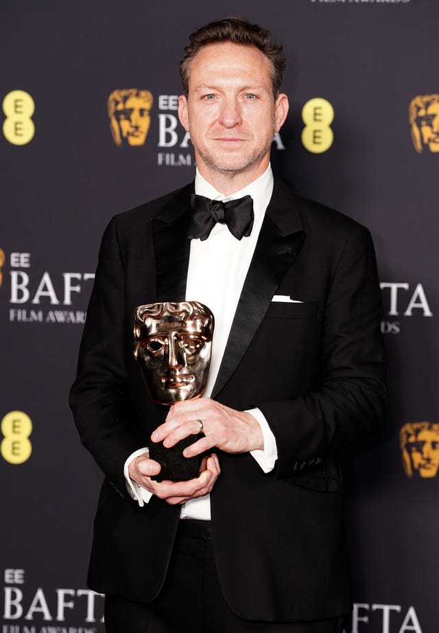 Lol Crawley with his Bafta award for best cinematography, which he won for the film The Brutalist 