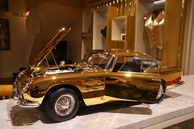 24-carat model of James Bond’s Goldfinger Aston Martin DB5 on display with its doors and bonnet open