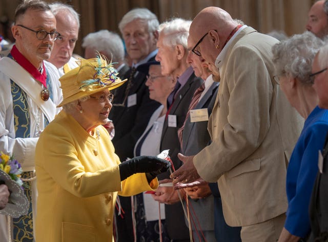 The Queen distributing Maundy money during last year's Royal Maundy Service at St George’s Chapel at Windsor Castle. Arthur Edwards/The Sun