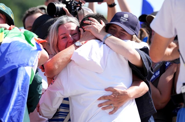 Tom Pidcock being congratulated by family