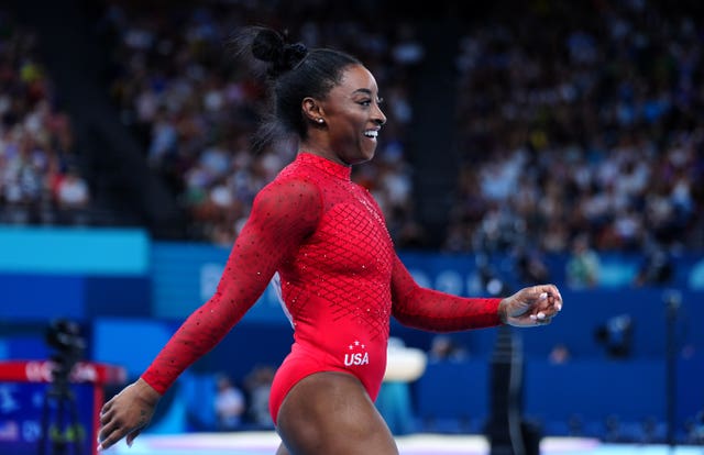 Simone Biles smiles after competing at the Paris Olympics. 