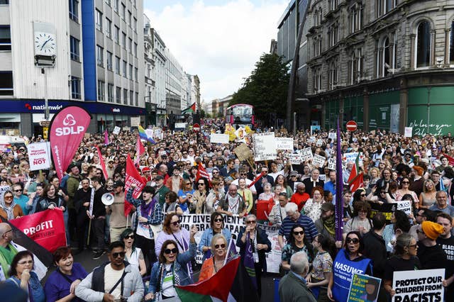 Demonstrators take part in a United Against Racism rally in Belfast