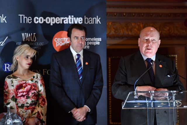 Lord Fellowes speaks as Emilia Clarke and Jonathan Ross look on during the awards ceremony (Ben Stansall/PA)