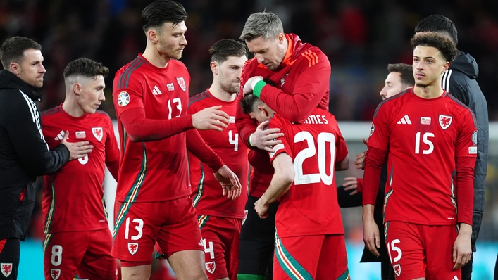 Daniel James is consoled by his Wales team-mates after missing from the spot in a penalty shoot-out against Poland (David Davies/PA)