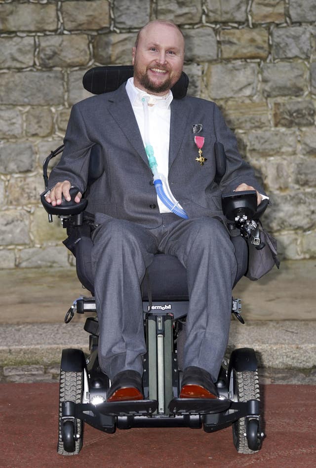 Matthew Hampson with his OBE following an investiture ceremony at Windsor Castle