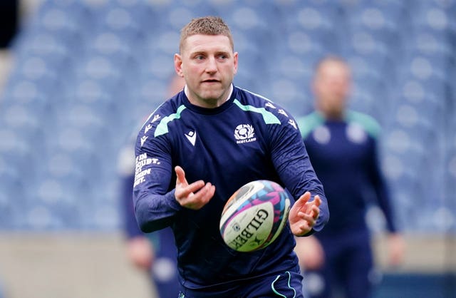 Finn Russell passes the ball during Scotland's team run