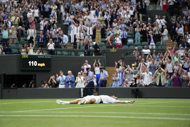 Cameron Norrie collapses to the floor in celebration after winning his match