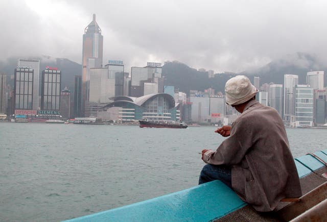A man overlooks the famous Victoria harbour towards Hong Kong’s business centre (Gareth Copley/PA)