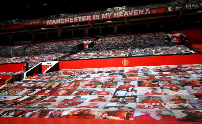 Fan pictures on banners covering the seats in the stands at Old Trafford