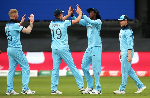 Jofra Archer, centre right, high-fives Chris Woakes as Ben Stokes, left, waits his turn