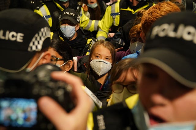 Greta Thunberg surrounded by police and activists in Glasgow