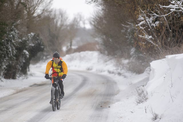 A cyclist makes his way through snow in Barham, near Ipswich 