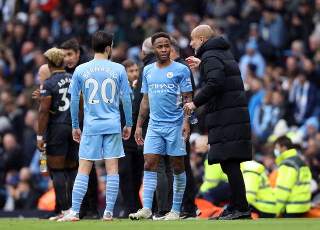Sterling (centre) has been well managed by Guardiola (right)