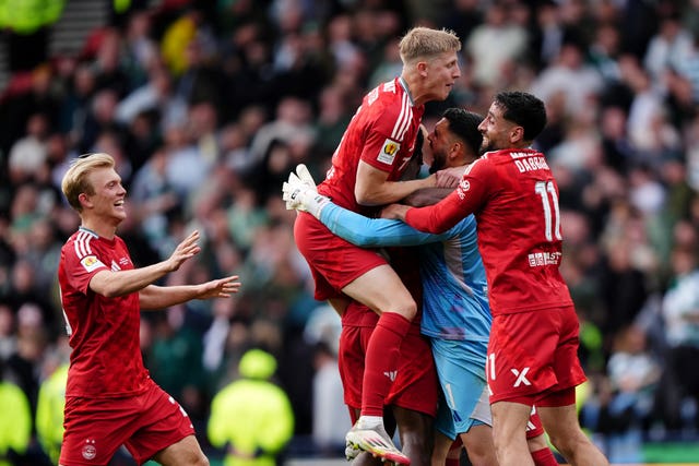 Aberdeen goalkeeper Dimitar Mitov (centre) celebrates with team-mates after saving the deciding penalty in the Scottish Cup final