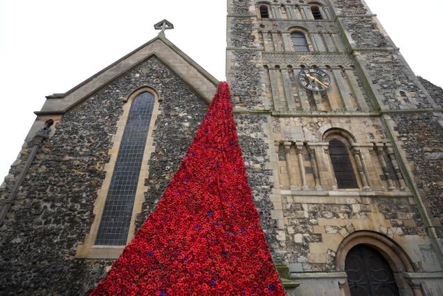 A view of the knitted poppies cascading down St. Mary’s Church in Dover, Ken