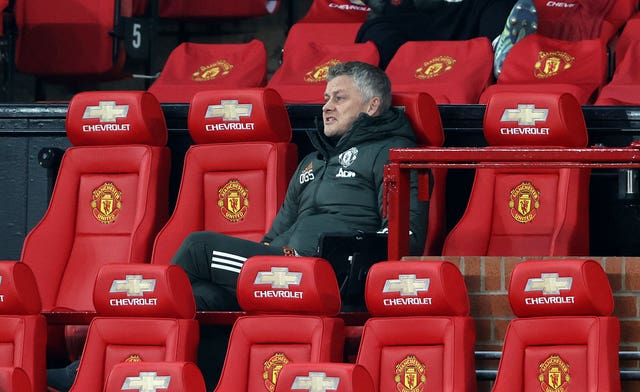 Ole Gunnar Solskjaer sits in the Chevrolet-covered Old Trafford dugout