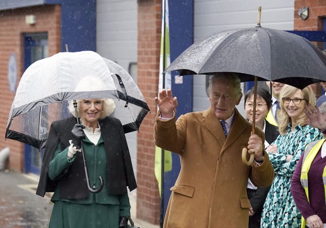 Charles and Camilla with umbrellas
