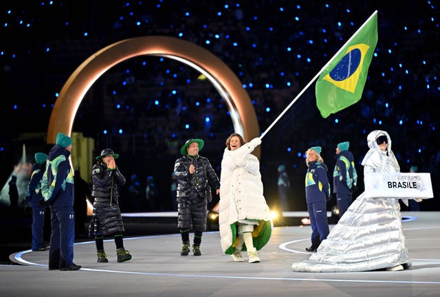 Lucas Pinheiro Braathen carries Brazil’s flag at the Winter Olympics Opening Ceremony