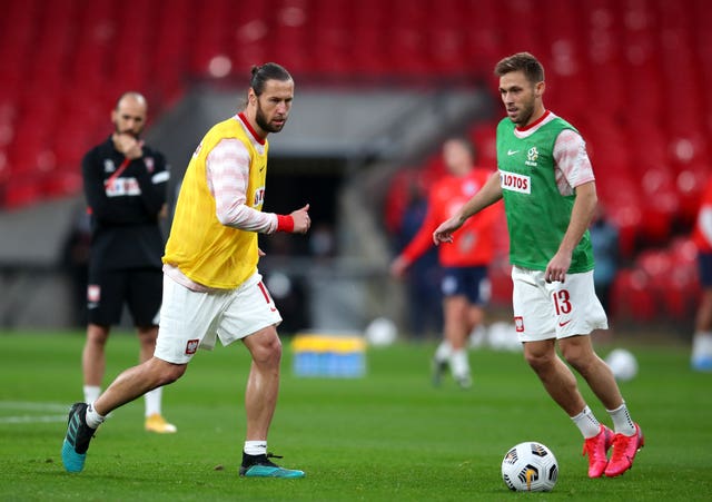 Grzegorz Krychowiak, left, and Maciej Rybus warm up prior to the World Cup qualifier against England at Wembley in March 2021