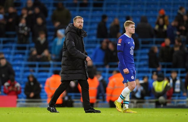 Graham Potter (left) looks dejected after Chelsea's defeat at Manchester City