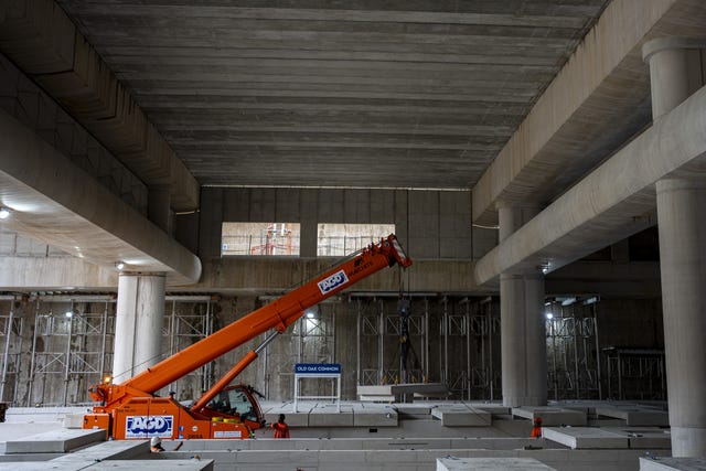 Construction workers lower a precast platform slab during the installation of the first high speed railway platforms for the HS2 project at Old Oak Common station, west London