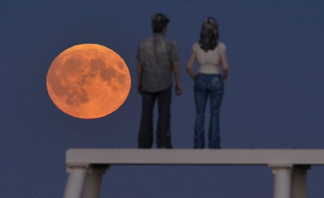 The supermoon over The Couple sculpture at Newbiggin-by-the-Sea in Northumberland