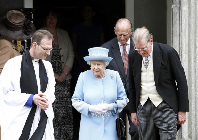 Queen Elizabeth II and the Duke of Edinburgh accompanied by Dean Kenneth Hall (left) walking between St Macartin’s Church of Ireland (Anglican) Cathedral and St Michael’s Catholic Church Enniskillen, Co Fermanagh, in 2012