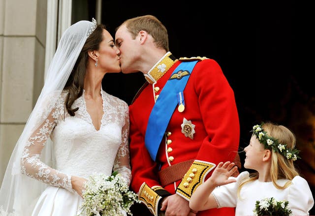 William and Kate kiss on the balcony of Buckingham Palace (PA)
