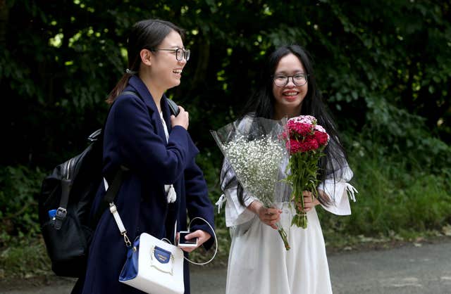 Students and film fans Yunyao Li, 23 (left) and Qiong dan Xu, 24, from Glasgow, at the main entrance to Wardhill Castle in Aberdeenshire