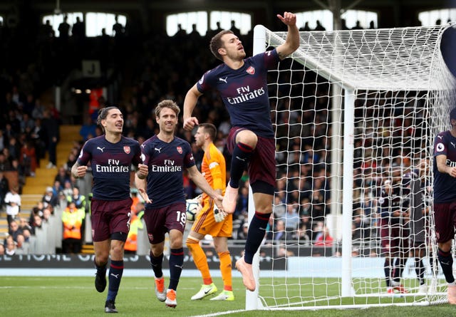 Aaron Ramsey celebrates a stunning Arsenal goal in a rout at Fulham.