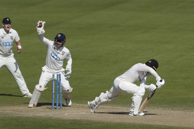 Ollie Robinson completes a stumping against Sussex last season.