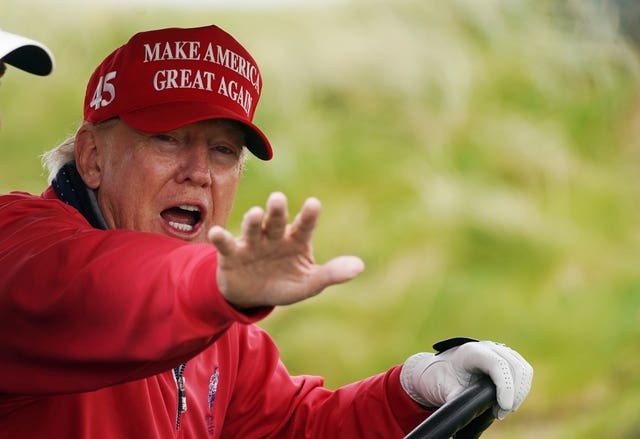 Donald Trump plays golf during a visit to Ireland