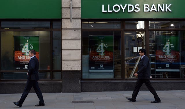 People walking past a branch of Lloyds Bank