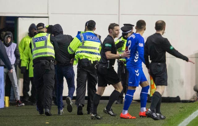 Rangers captain James Tavernier found himself face to face with a fan who had jumped out of the Hiberian support before being led away 