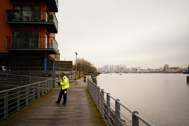 A police officer near the scene beside the Thames 