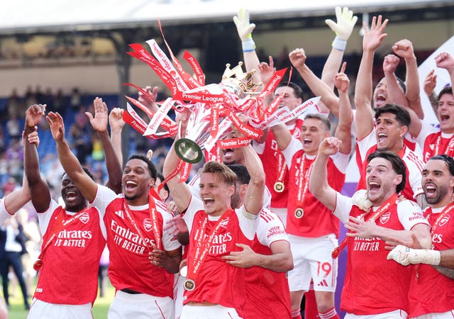 Arsenal’s Martin Odegaard lifts the Premier League trophy 