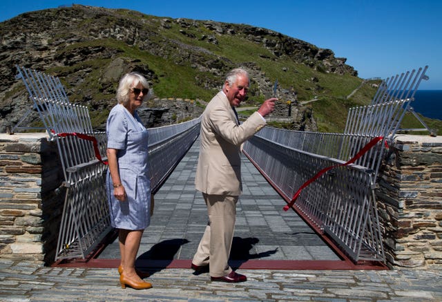 Charles cuts the ribbon to officially open the walkway. Geoff Caddick/PA Wire