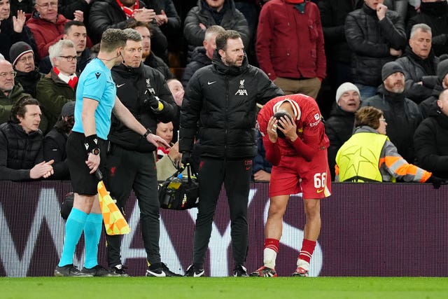 Liverpool’s Trent Alexander-Arnold, right, puts his head in his hands after his injury against Paris St Germain